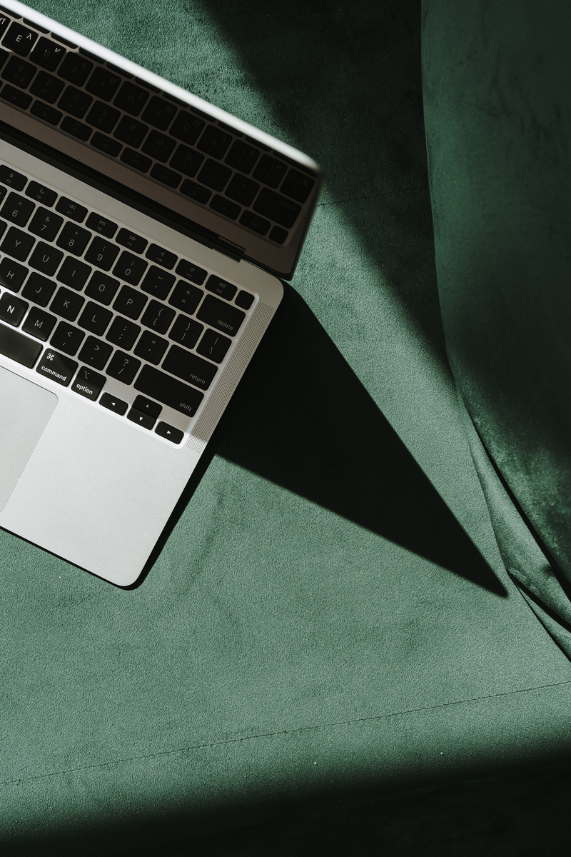Laptop on Green Sofa